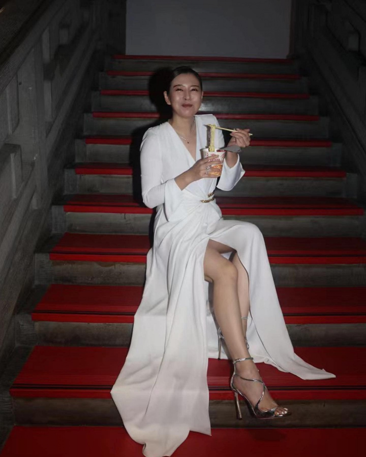 言言穿著白色仙氣禮服一邊吃泡麵