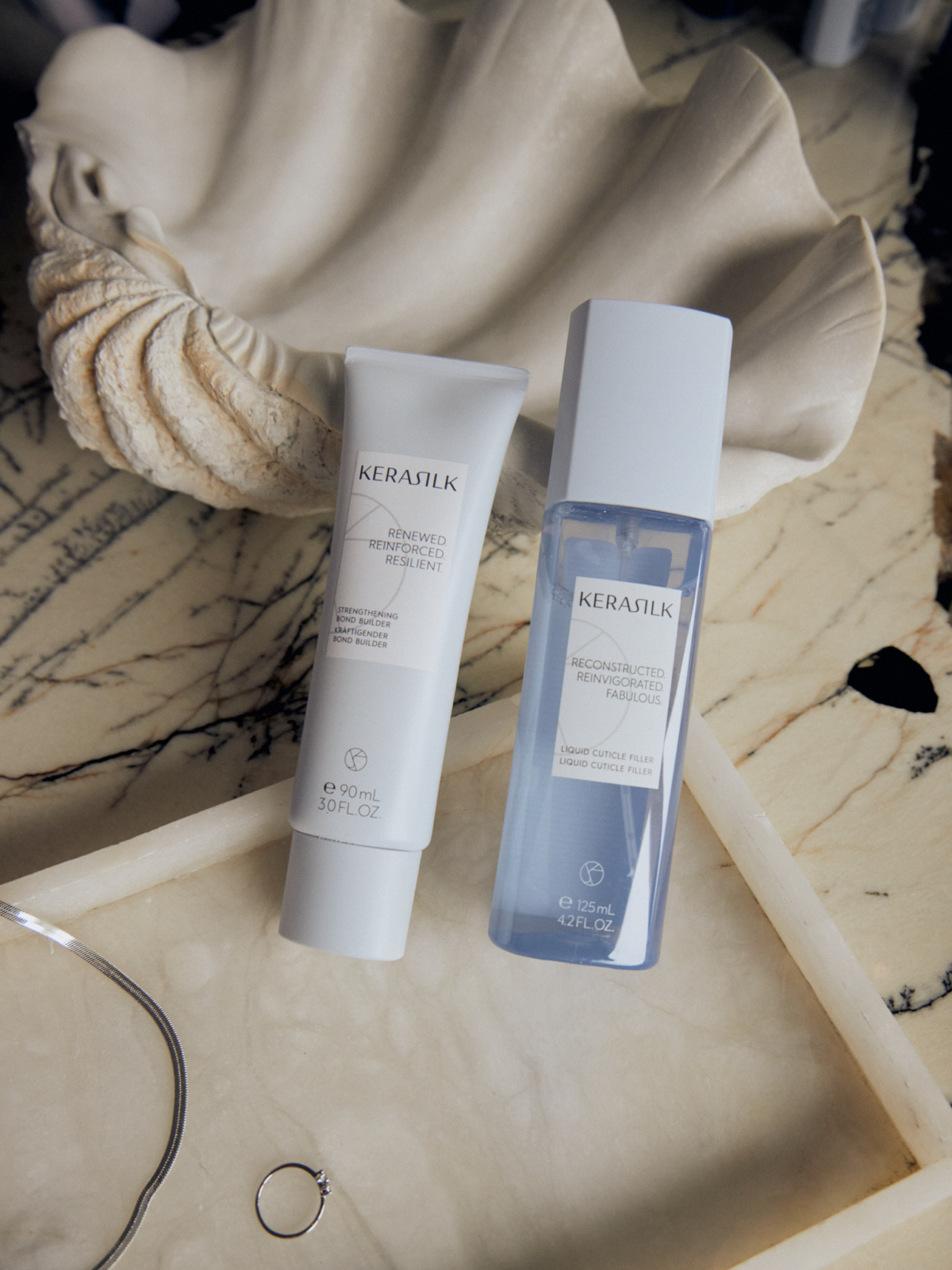 KERASILK 絲馭洸 髮繃帶重建乳 90ml，NT$1,200 / 髮繃帶緊緻露 125ml，NT$1,200