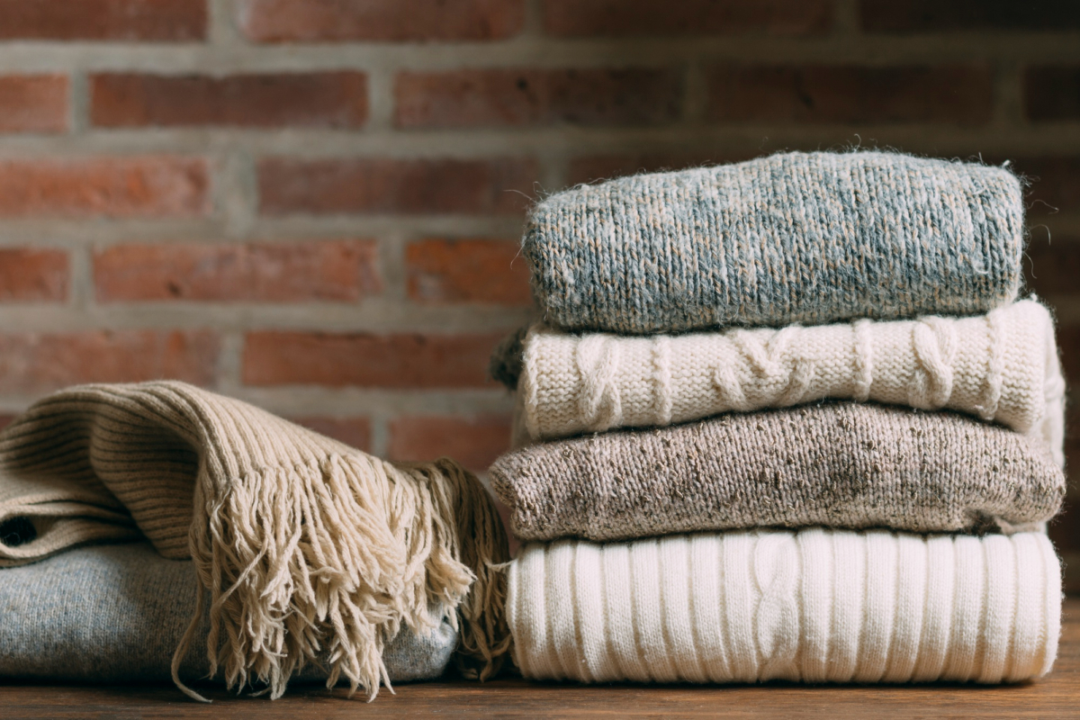 different knitwear folded on a desktop